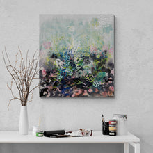 Load image into Gallery viewer, Dawn Chorus original painting by Tania LaCaria displayed hanging on a white wall in a studio with paint rollers and paint jar and a white vase with branches on a white desk..

