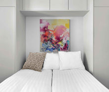 Load image into Gallery viewer, Good Start original painting by Tania LaCaria displayed hanging in the niche opening of a bedroom with built-in storage around the bed that is dressed in white linens with one geometric beige pillow and other white pillows
