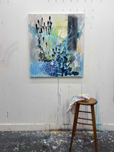Load image into Gallery viewer, Homecoming by Tania LaCaria original painting hanging on a white wall in the artist's studio with a wooden stool in the foreground