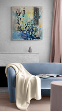 Load image into Gallery viewer, Homecoming by Tania LaCaria original painting hanging on a white wall in a living room with a blue sofa that compliments the blue colors in the painting.

