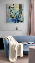 Load image into Gallery viewer, Homecoming by Tania LaCaria original painting hanging on a white wall in a living room with a blue sofa that compliments the blue colors in the painting.