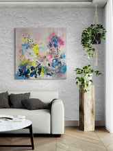 Load image into Gallery viewer, Offbeat original painting by Tania LaCaria displayed on a white stucco wall in a living room with plant displays and a white sofa.
