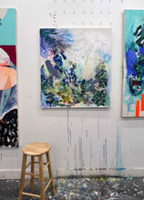 Load image into Gallery viewer, Whisper original painting by Tania LaCaria displayed hanging on a white wall between two other paintings that can&#39;t be seen in the artist&#39;s studio with a wood stool in the foreground.
